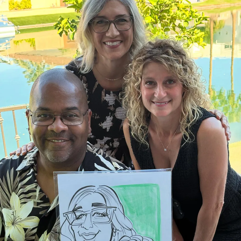 Adam Street smiling poolside with two guests who hold up their Adam Street caricature